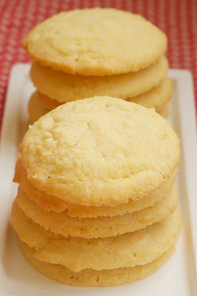 Cornmeal Cookies stacked on a white plate