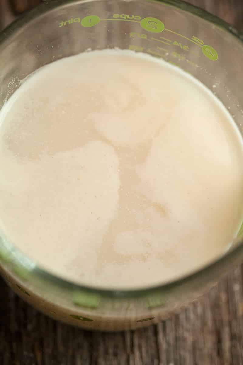 a close up of a mixing cup with yeast as it begins to foam