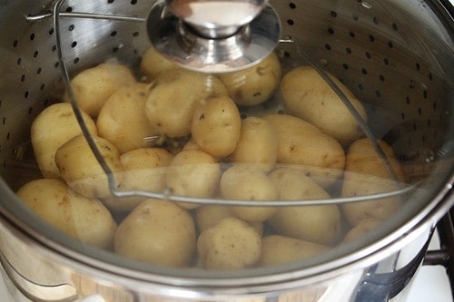 Steamed Potatoes in pot with glass lid.