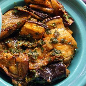 A small tagine filled with oven-roasted chunks of eggplant marinated in chermoula.