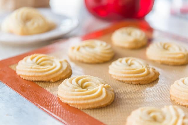 Shortbread Cookie Recipe - Served On a Silicone Mat in Rows with a Piped Swirl Shape